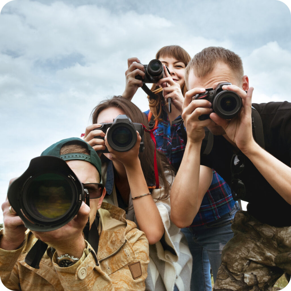 four people using their cameras